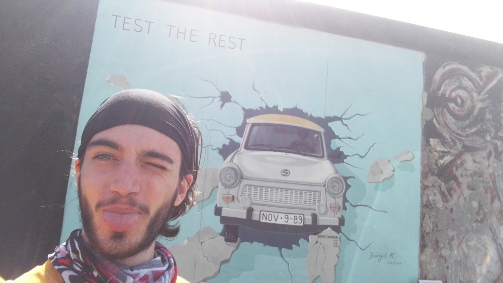Picture: David, our summer student, in front of the Berlin wall.