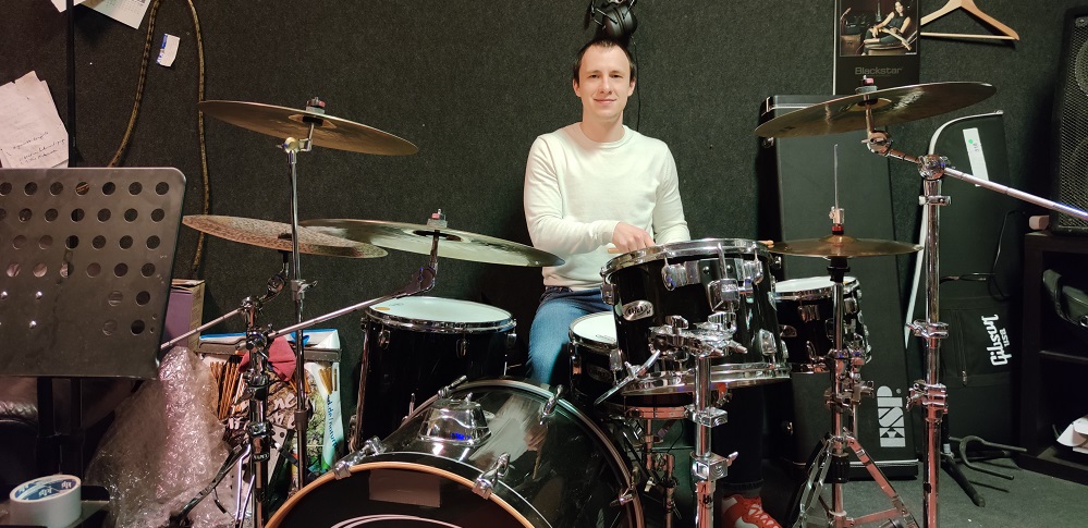 PhD Student Denis Antipin playing the drums.